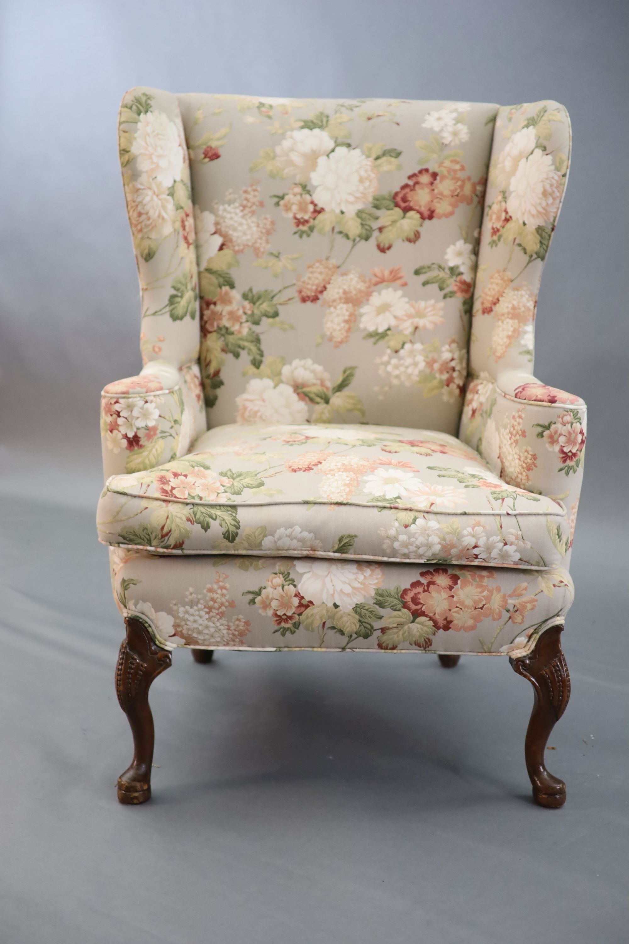 A French Hepplewhite style wing armchair together with a matching contemporary footstool